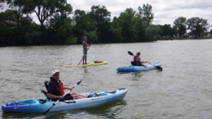 Image of people kayaking and paddle boarding on St. James Lake